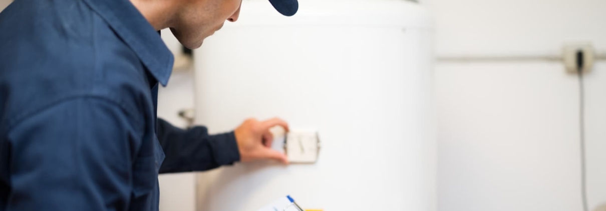 technician evaluating a hot water heater